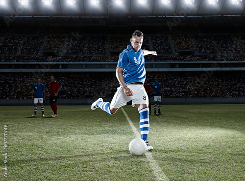 Soccer player kicking ball on field © KOTO