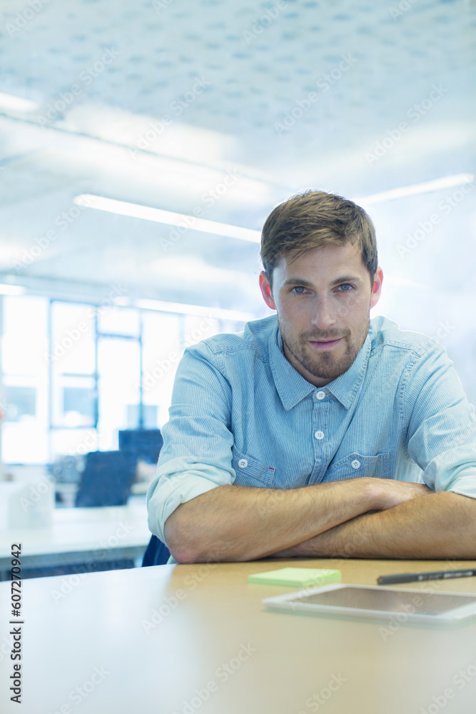 Businessman sitting at desk in office Businessman sitting at desk in office
