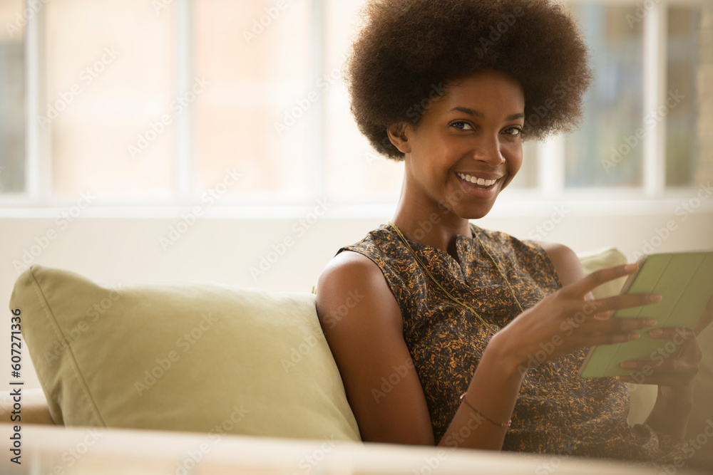 Woman using digital tablet on sofa Woman using digital tablet on sofa