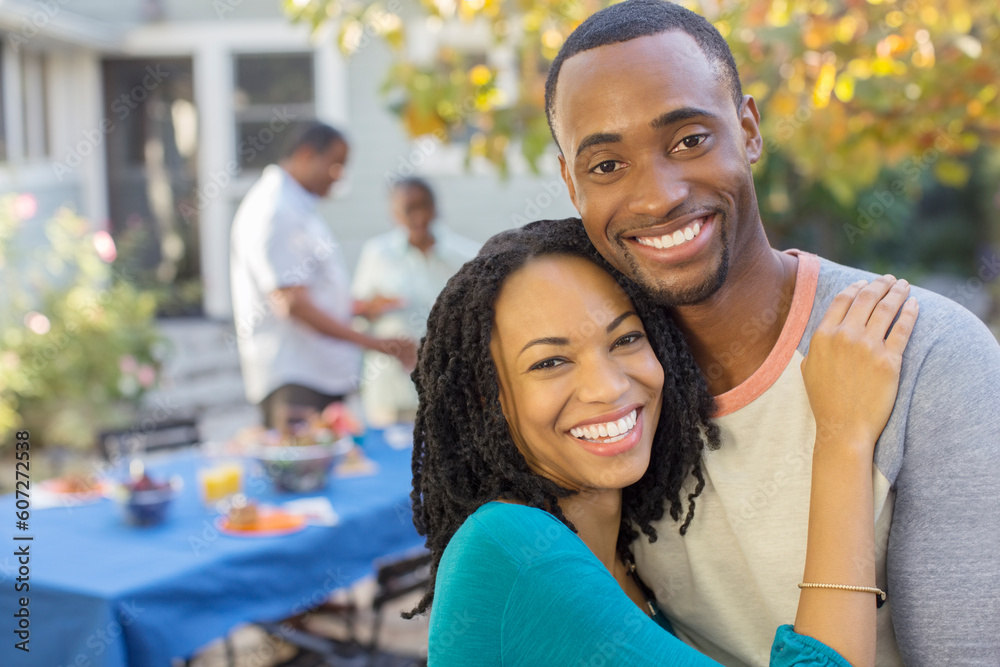 Portrait of happy couple near patio table