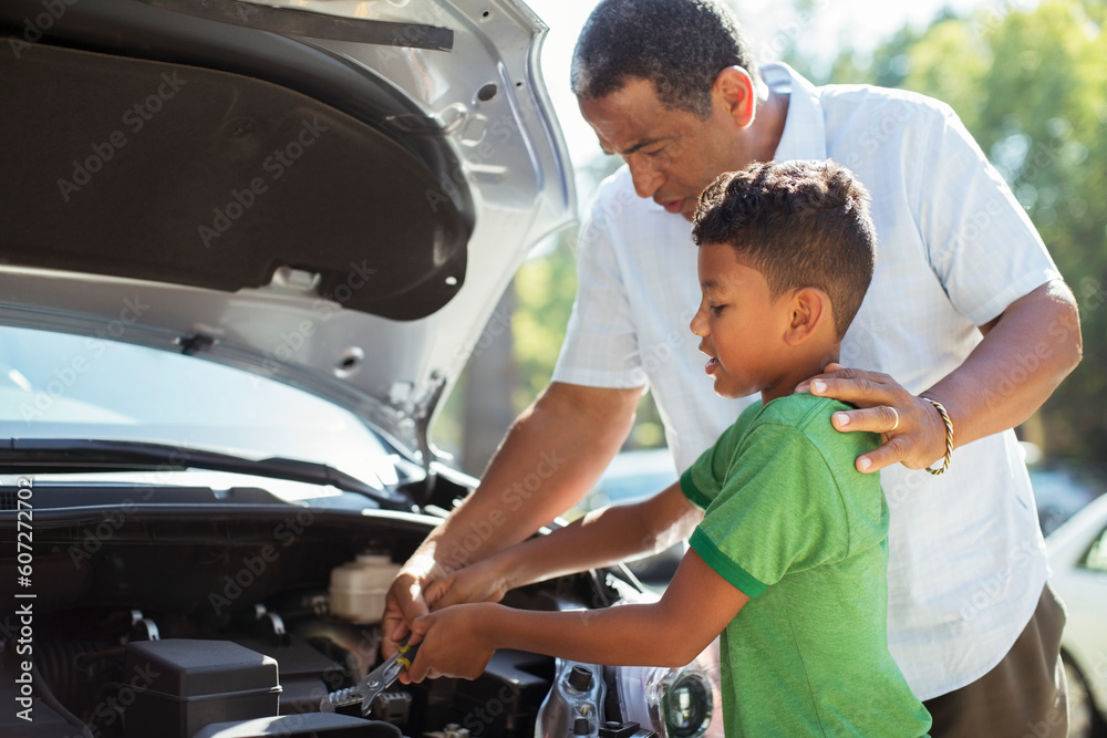 Grandfather and grandson repairing car engine Grandfather and grandson repairing car engine