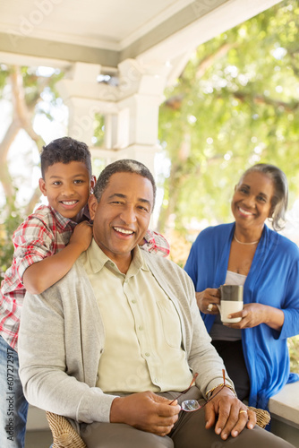 Portrait of smiling grandparents and grandson on porch