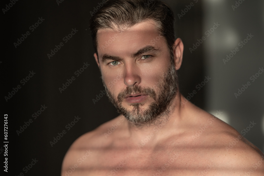 Cosmetics, body care and spa treatment. Portrait of masculinity charming shirtless man isolated over white background. Close-up portrait of attractive guy.