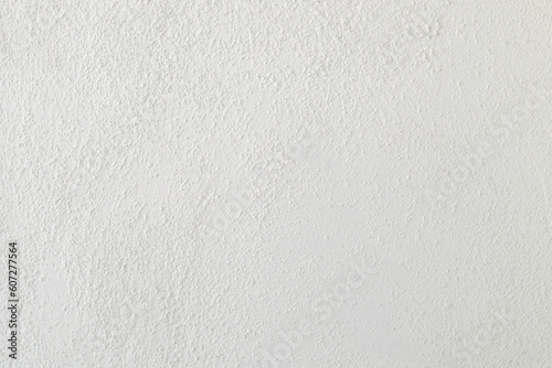 Rough white drywall surface texture as background, so called popcorn technique photo