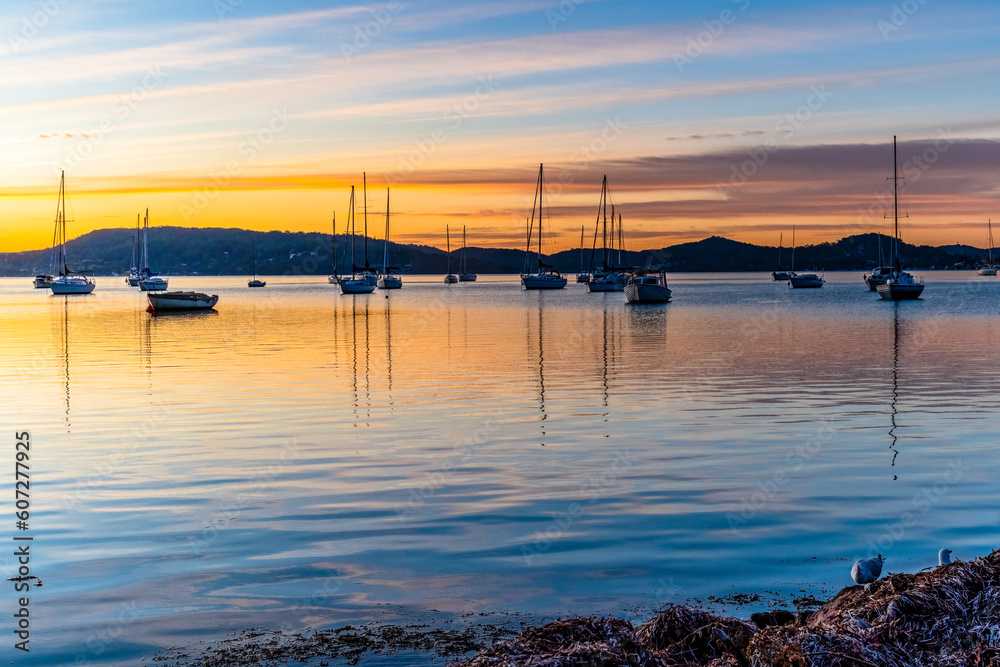 Beautiful sunrise with high cloud and boats on the water