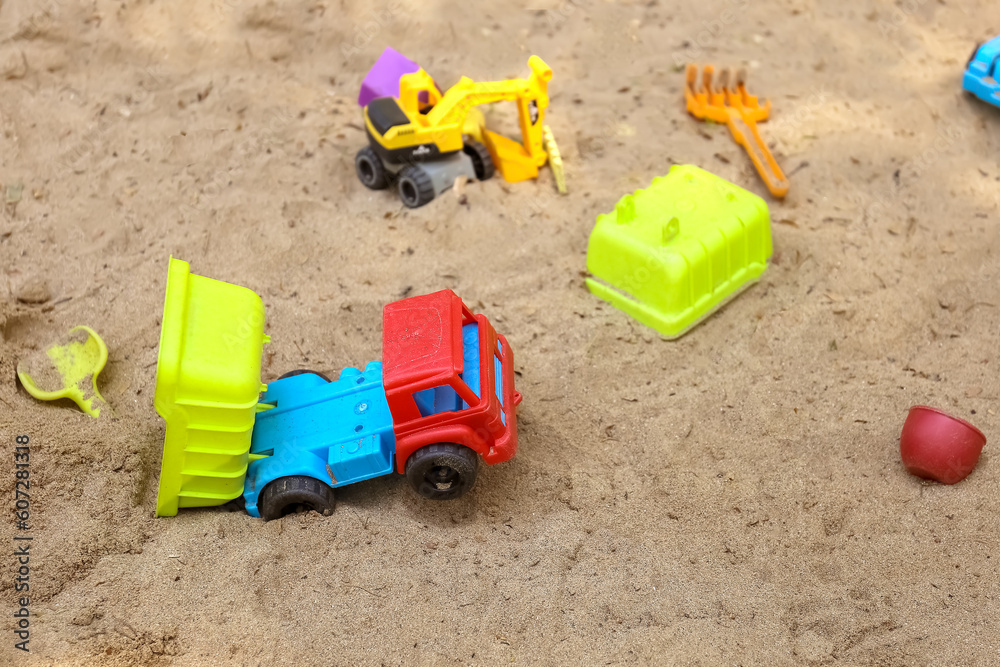 Children's toys on the sand ,dump truck, backhoe Children's toys on the sand ,dump truck, backhoe
