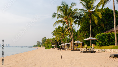 The beautiful beach of Bangsaray Pattaya Thailand at sunset with sunbeds and umbrellas at the beach © Chirapriya