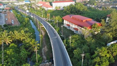drone fly over bridge crosses even the river, Aerial view of cars driving on bridge in morning time at Chalermpragiad bridge Pattani,Thailand
