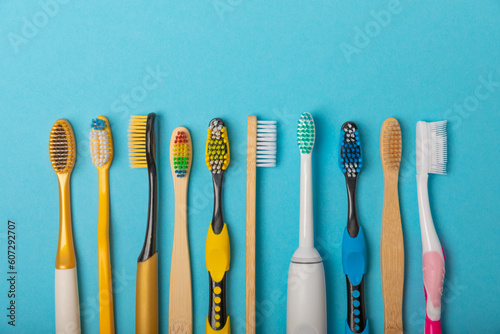 Foto Electric and manual toothbrushes on a blue background