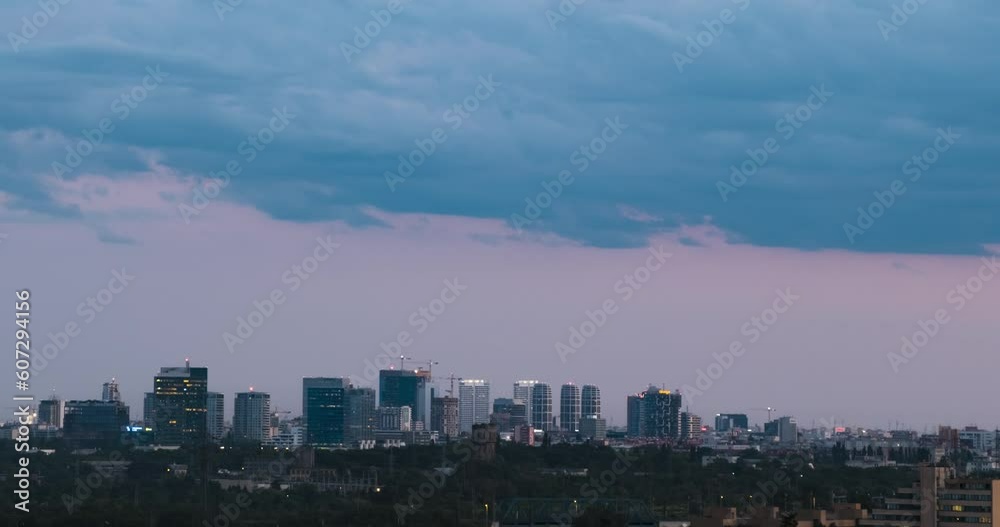 Cityscape sunset time lapse. The silhouettes of skyscrapers and urban buildings against the background of clouds. City modern intensive life. Cityscape sunset time lapse. The silhouettes of skyscrapers and urban buildings against the background of clouds. City modern intensive life.