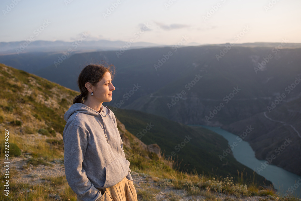 harmony with nature. person contemplates. girl looks at sunset in mountains