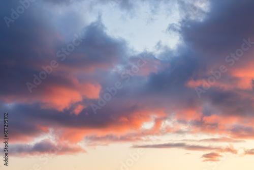 Beautiful sunset sky. Clouds illuminated by red sunlight at sunset. This view of the sky with clouds at sunset is great for background and design.