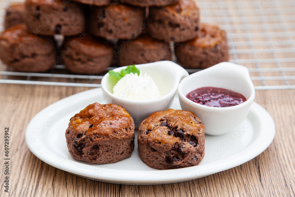 Chocolate scone with clotted cream and homemade raspberry jam Chocolate scone with clotted cream and homemade raspberry jam