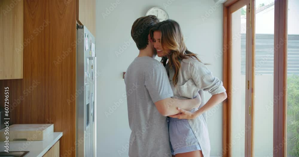 Young couple, dance and together in kitchen, home and morning with love, happiness and bonding. Man, woman and comic dancing with hug, spinning and steps with romance, care and happy in apartment Young couple, dance and together in kitchen, home and morning with love, happiness and bonding. Man, woman and comic dancing with hug, spinning and steps with romance, care and happy in apartment