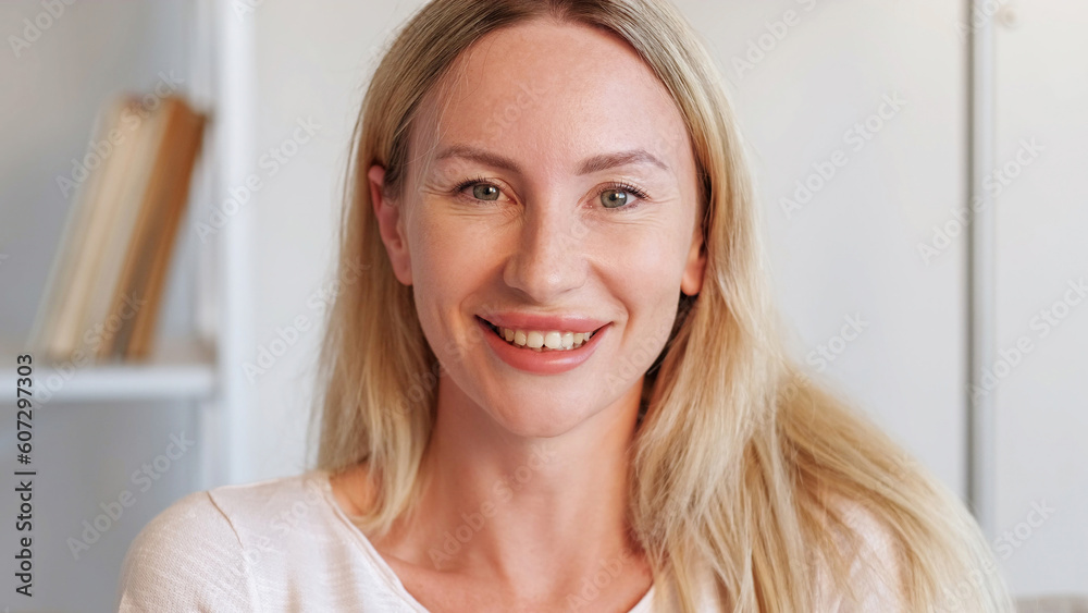 Smiling woman portrait. Good mood. Positive emotions. Satisfied joyful blonde lady expressing happiness at home interior free space. Smiling woman portrait. Good mood. Positive emotions. Satisfied joyful blonde lady expressing happiness at home interior free space.