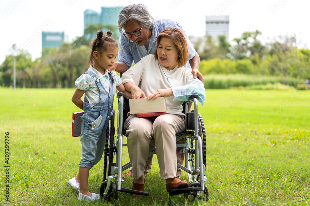 Portrait of happy love asian grandfather with grandmother and asian little cute girl enjoy relax in summer park.Young girl with their laughing grandparents smiling together.Family and togetherness Portrait of happy love asian grandfather with grandmother and asian little cute girl enjoy relax in summer park.Young girl with their laughing grandparents smiling together.Family and togetherness