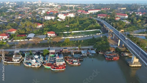 Aerial shot commercial ocean fishing boat floating on the river back to the harbour at morning time 