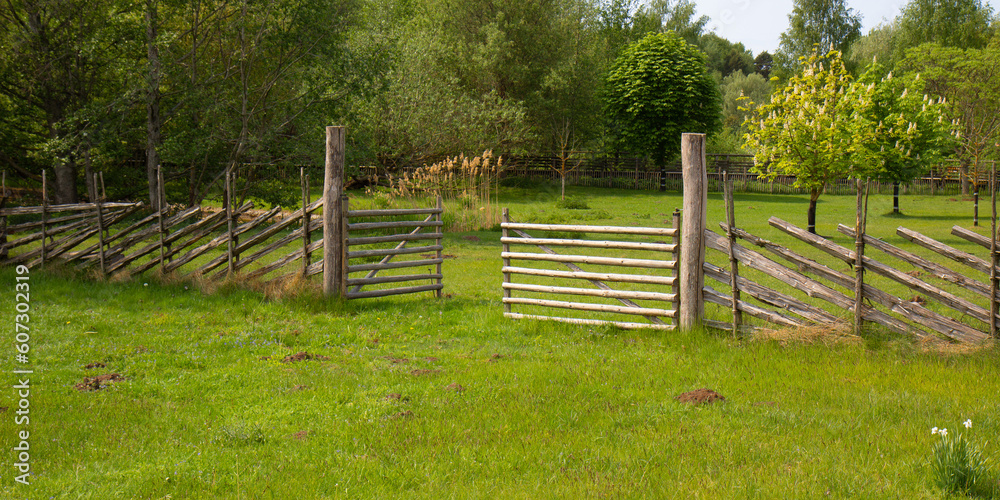 Rural view of a traditional wooden gate set in the countryside