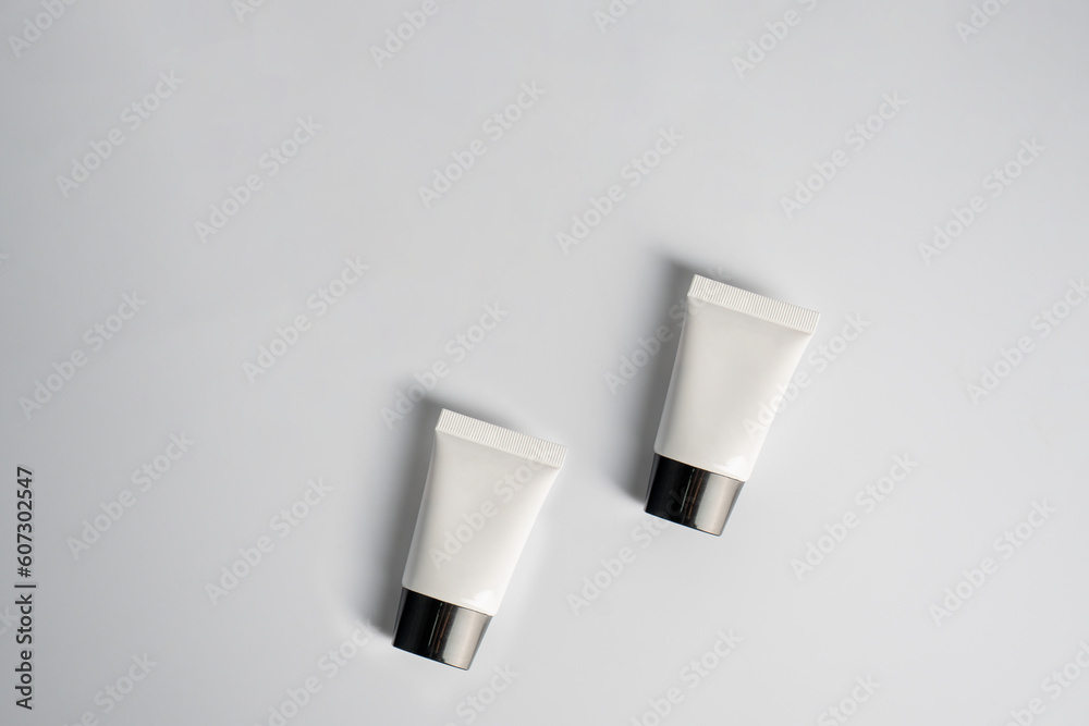 Plastic white tube for cream or lotion. Skin care or sunscreen cosmetic on white background Plastic white tube for cream or lotion. Skin care or sunscreen cosmetic on white background