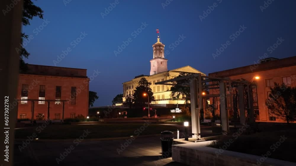 Tennessee State Capitol building at night in Nashville, Tennessee with drone video moving low and forward close up.