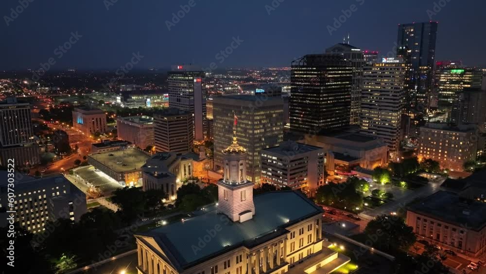 Tennessee State Capitol building at night in Nashville, Tennessee with drone video moving down and close up.