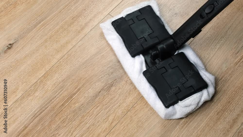 the process of cleaning and washing the floor with a steam mop, top view. The concept of environmentally friendly cleaning and disinfection of the house. the process of cleaning and washing the floor with a steam mop, top view. The concept of environmentally friendly cleaning and disinfection of the house.