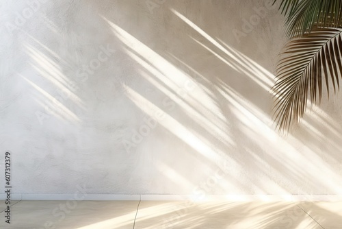 Fotografia Shadow of palm leaves on white concrete light beige wall