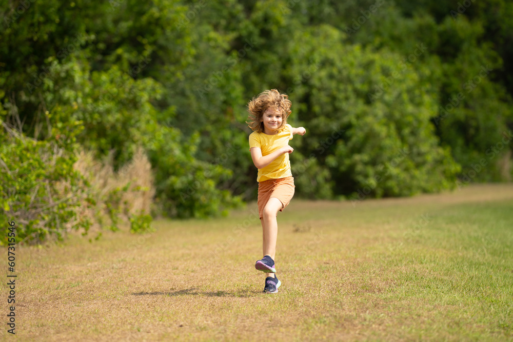 Young kid running and smiling in the park. Active little kid running along street during leisure sport activity. Sporty kid running in nature. Child run. Kids running. Summer sport. Happy childhood. Young kid running and smiling in the park. Active little kid running along street during leisure sport activity. Sporty kid running in nature. Child run. Kids running. Summer sport. Happy childhood.