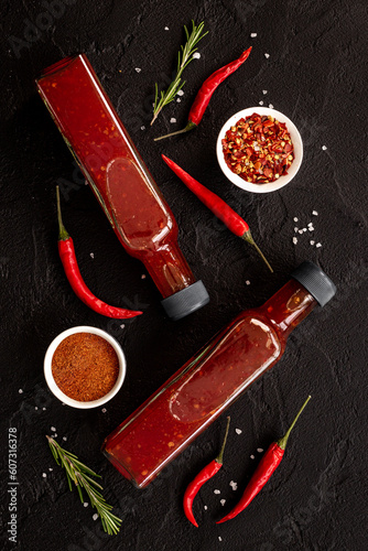 Red chili sauce ketchup or tabasco with ripe hot pepper