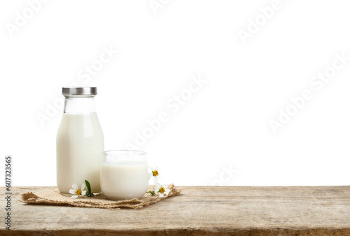 A bottle of milk and glass of milk on a wooden table with transparent background png, nutritious and healthy dairy products
