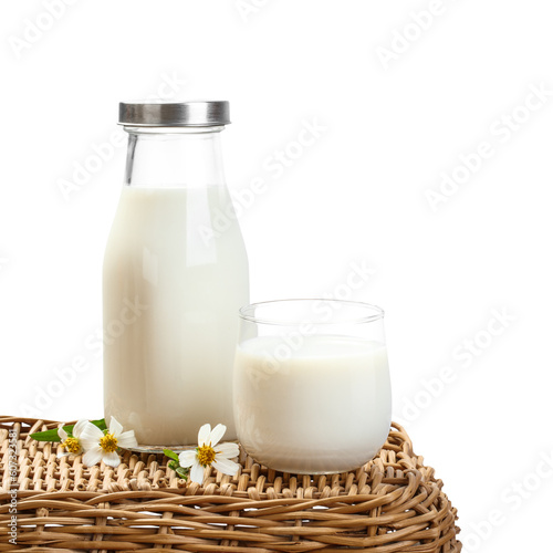 A bottle of milk and glass of milk on a basket table with transparent background png, nutritious and healthy dairy products