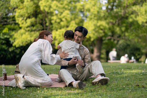 公園でピクニックをする家族 © monzenmachi