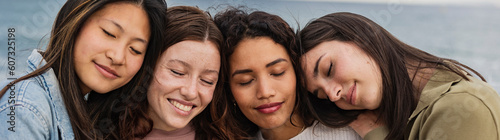 Group of diverse women standing together with eyes closed panoramic