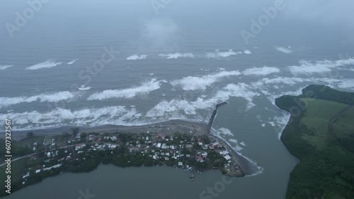 Wallpaper Mural Drone footage approaching to breakwater and waves approaching to coast in Barra de Sontecomapan Veracruz Mexico. Drone goes through a cloud Torontodigital.ca