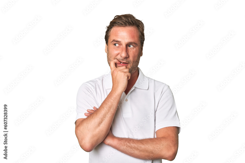 A middle-aged man isolated relaxed thinking about something looking at a copy space. A middle-aged man isolated relaxed thinking about something looking at a copy space.