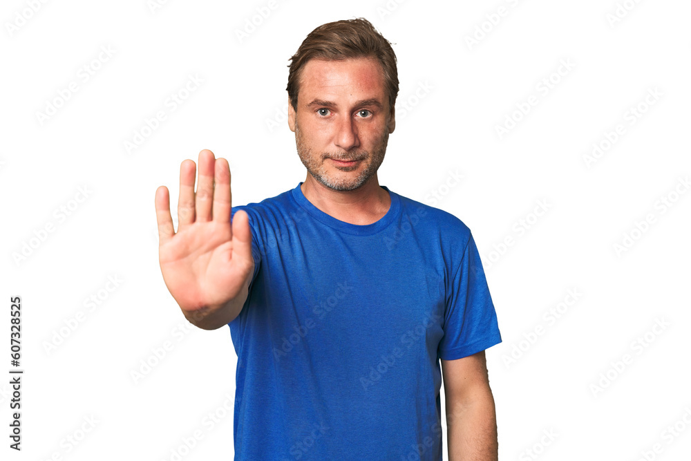 A middle-aged man isolated standing with outstretched hand showing stop sign, preventing you. A middle-aged man isolated standing with outstretched hand showing stop sign, preventing you.