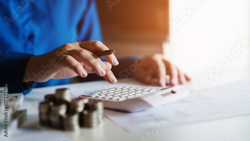 Woman calculating monthly expenses, taxes and interest calculate at home.