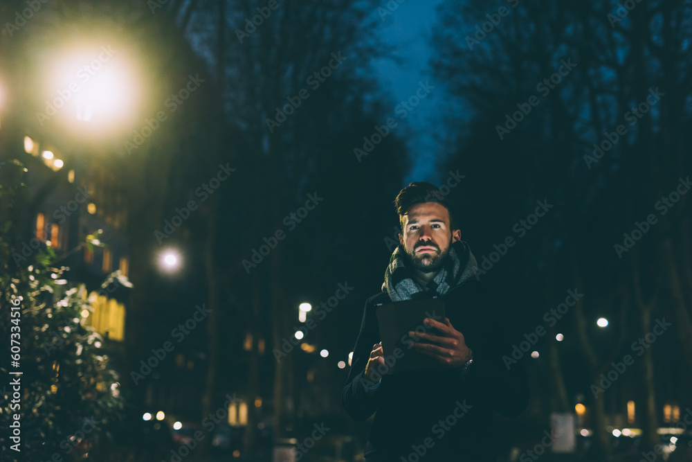 Young businessman outdoor night using tablet