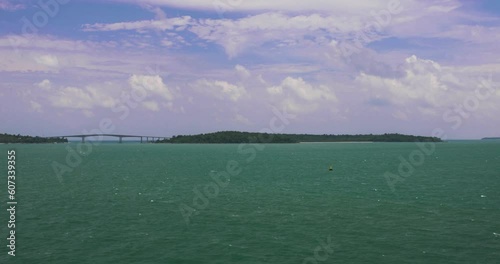 Kaoh Puos Bridge with Turquoise Ocean in Sihanoukville, Cambodia. Wide Angle Shot. photo