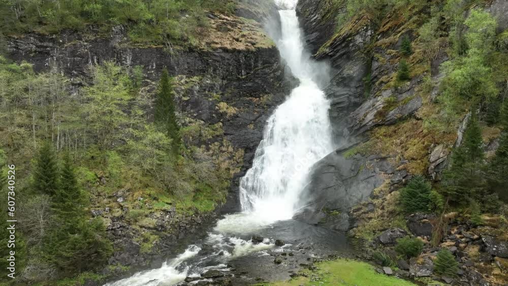 Epic Huldefossen waterfall in Norway - Rising aerial revealing all of the waterfall coming down hillside Epic Huldefossen waterfall in Norway - Rising aerial revealing all of the waterfall coming down hillside
