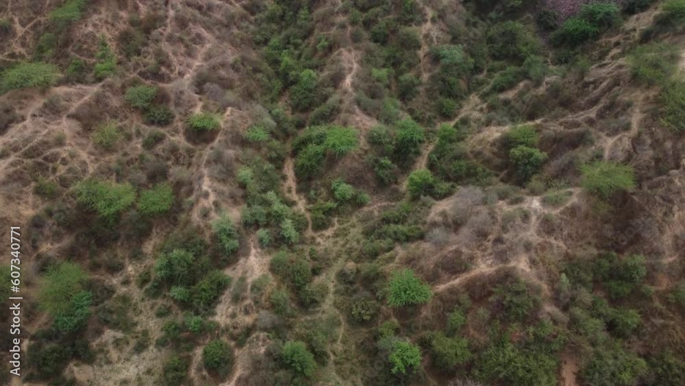 Slow aerial view of the unique gully erosions of the iconic badlands of Chambal ravines next to the national highway in Morena Rajasthan Madhya Pradesh border used by dacoits to flee or hide in, India Slow aerial view of the unique gully erosions of the iconic badlands of Chambal ravines next to the national highway in Morena Rajasthan Madhya Pradesh border used by dacoits to flee or hide in, India