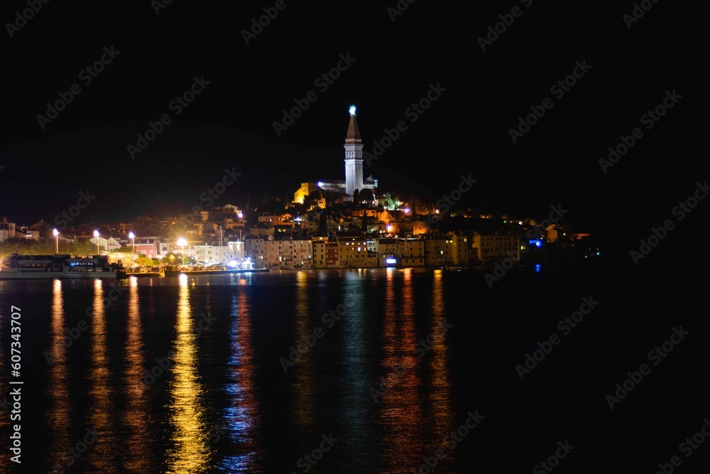 Istria peninsula with Rovinj city lights reflecting on the surface of the sea in Croatia