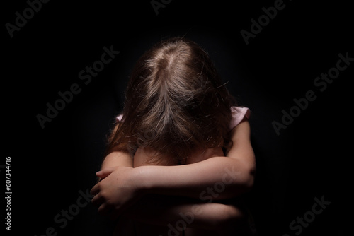 Sad depressed little girl crying closing her face