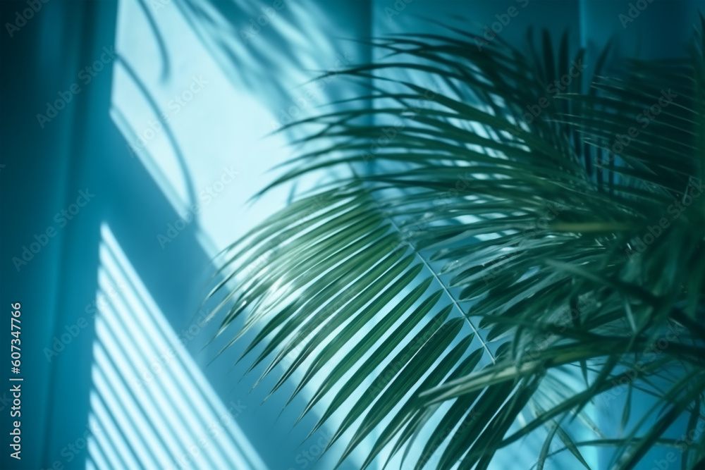 Blurred shadow from palm leaves on the blue wall