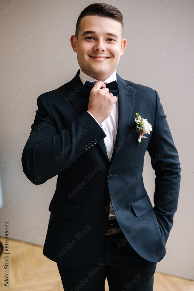 Portrait of handsome groom in dark blue suit preparing for first view with bride. Wedding day Portrait of handsome groom in dark blue suit preparing for first view with bride. Wedding day