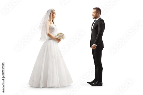 Full length profile shot of a bride looking at a groom
