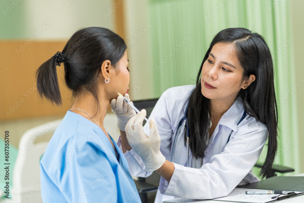 Asian woman consulting about Cosmetic surgeon and make Botox injections on face for beauty procedures. Plastic surgery in face of woman Asian woman consulting about Cosmetic surgeon and make Botox injections on face for beauty procedures. Plastic surgery in face of woman