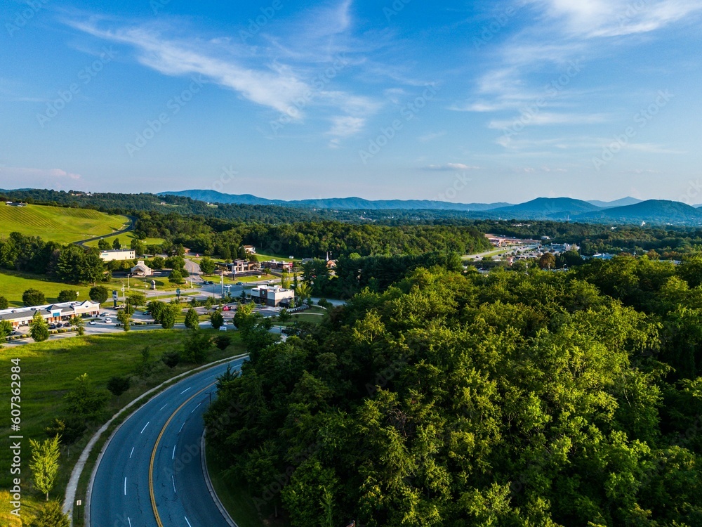 Aerial shot of a highway amid the green forests and valleys in Roanoke, VA, USA