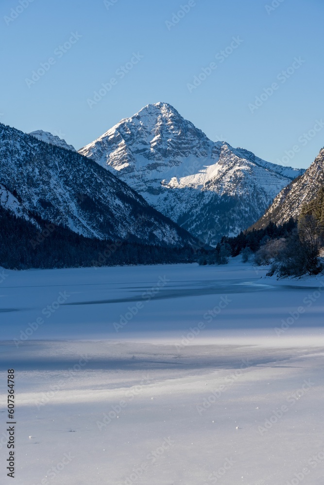 Vertical shot of the snow-covered Alps and the Lake Plansee in Austria Vertical shot of the snow-covered Alps and the Lake Plansee in Austria