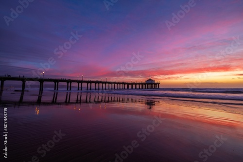 Aerial view of sea waves breaking beach during sunset © Randal Finklea/Wirestock Creators